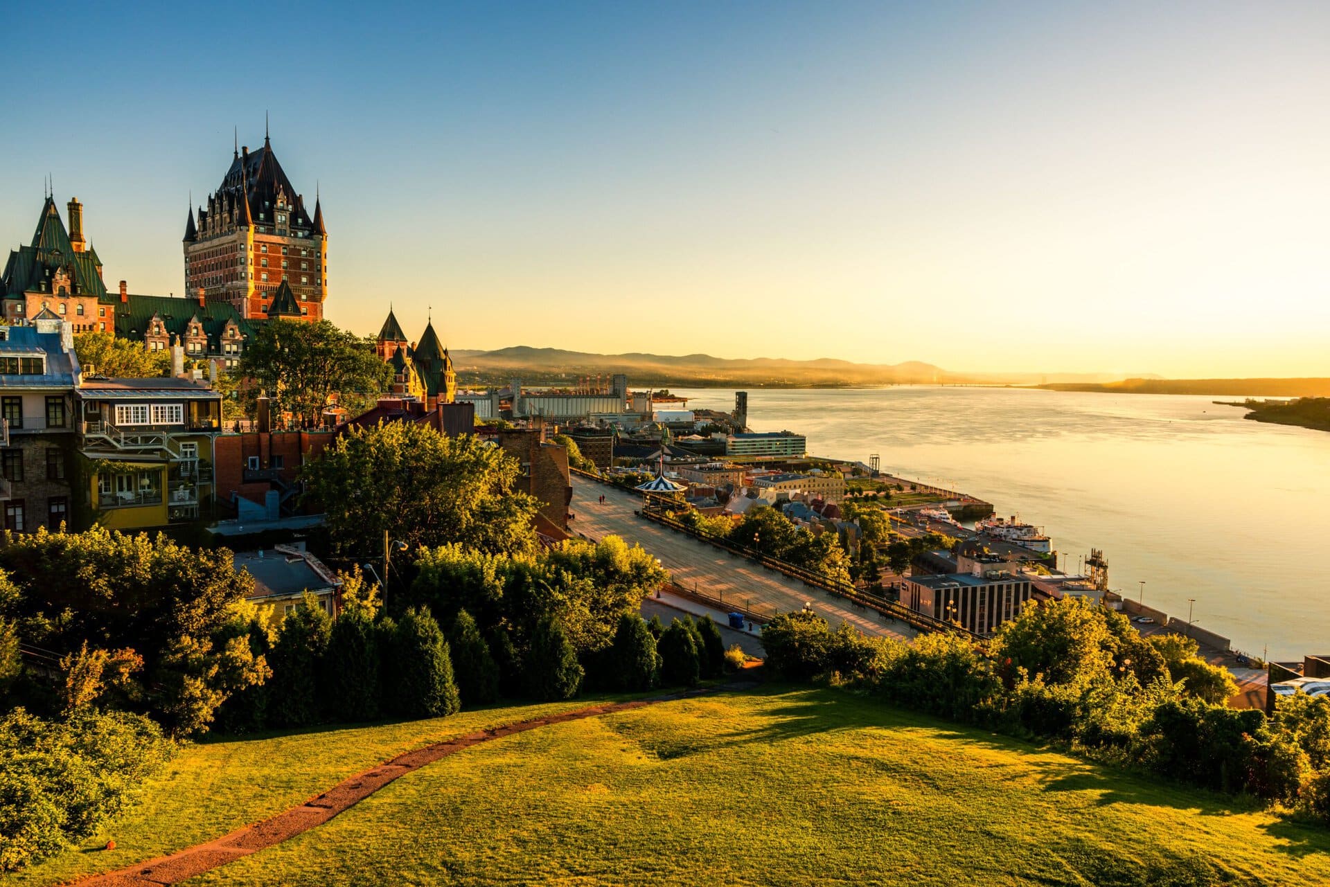 Green hill and historic buildings near the river in Quebec City