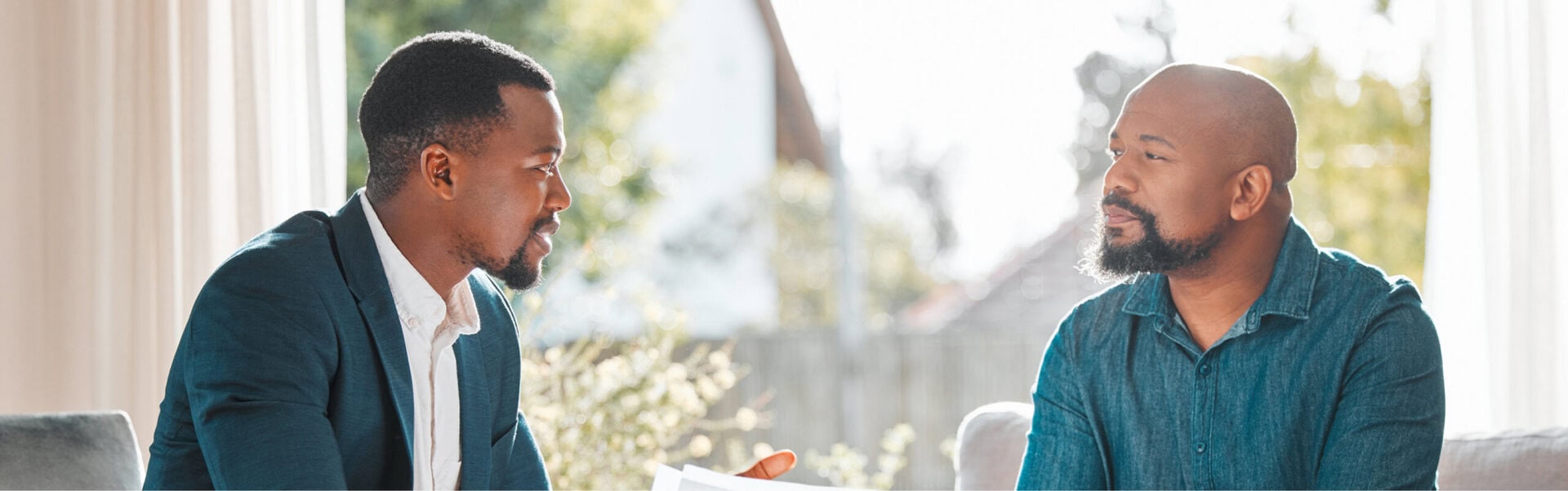Two men discuss career coaching results in a casual office setting