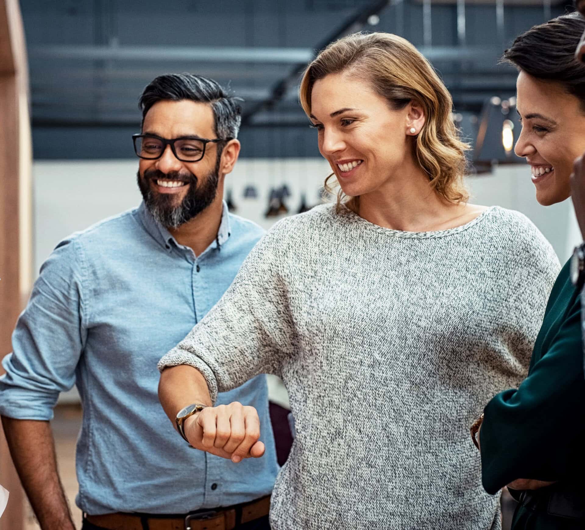 Three smiling employees time a team-building activity