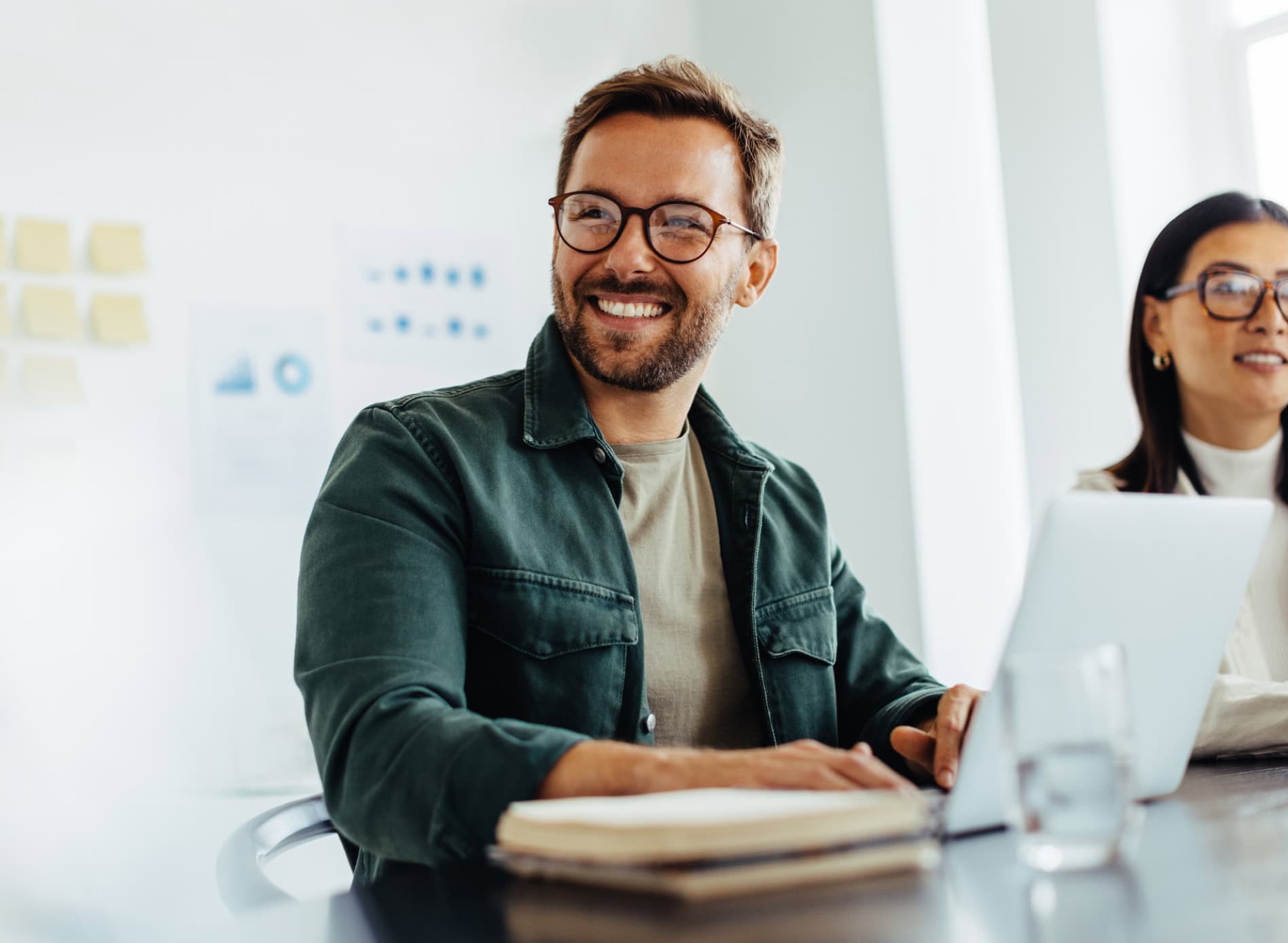 A man at a desk smiles during a career development workshop